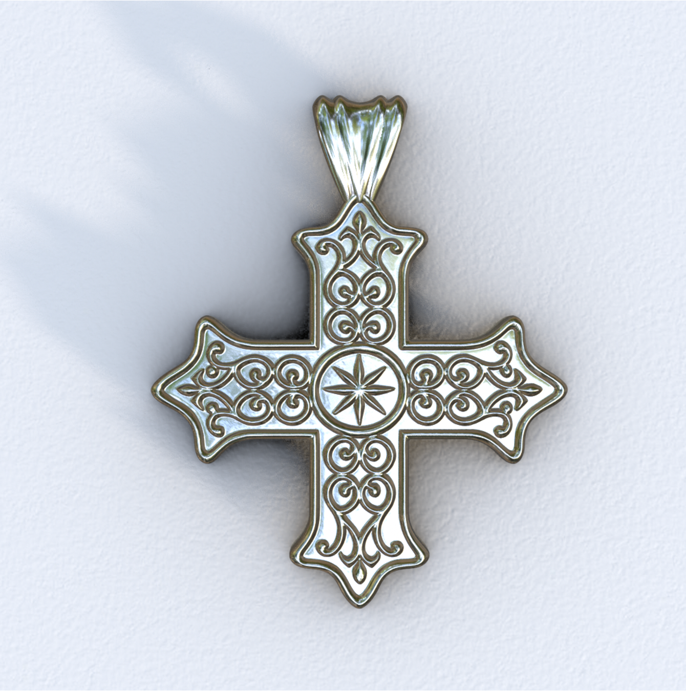 Silver cross pendant with intricate designs on a white background