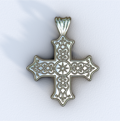 Silver cross pendant with intricate designs on a white background