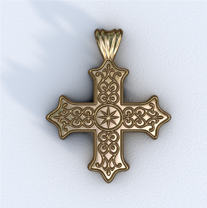 Gold cross pendant on a white background